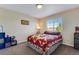 Cozy bedroom featuring a large window, carpeted floors, neutral colors, and ample closet space at 17035 E 102Nd Pl, Commerce City, CO 80022