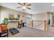 Upstairs bonus room featuring neutral colors, a ceiling fan, and flexible space for work or play at 17035 E 102Nd Pl, Commerce City, CO 80022