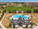 Aerial view of Reunion's pool, barn pavilion, and spacious park perfect for recreation at 17035 E 102Nd Pl, Commerce City, CO 80022