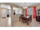 Open-concept dining room featuring tile floors and easy access to the living room and entryway at 17035 E 102Nd Pl, Commerce City, CO 80022