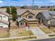 Aerial view of a two-story home with well-maintained lawn and neutral color palette at 17035 E 102Nd Pl, Commerce City, CO 80022