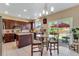 Eat-in kitchen with stainless appliances, dark wood cabinetry and glass table with easy backyard access at 17035 E 102Nd Pl, Commerce City, CO 80022