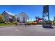 Exterior view of the Reunion Recreation Center with a water tower and slide nearby, with surrounding landscaping at 17035 E 102Nd Pl, Commerce City, CO 80022