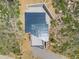 Aerial view showcasing a modern home with gray roof and stone patio in a natural setting at 718 Emerson Gulch Rd, Boulder, CO 80302