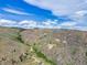 Breathtaking aerial perspective showcases homes nestled in a scenic mountain valley with clear blue skies at 718 Emerson Gulch Rd, Boulder, CO 80302