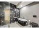 Stylish bathroom with a standalone tub, a glass-enclosed shower, and modern starburst-patterned tile create a luxurious space at 718 Emerson Gulch Rd, Boulder, CO 80302