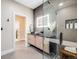 Modern bathroom with a glass shower, stone tiles, lighted mirror, and wood vanity at 718 Emerson Gulch Rd, Boulder, CO 80302