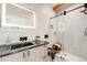 Sleek bathroom features a walk-in shower, black fixtures, modern vanity, and a decorative lighted mirror at 718 Emerson Gulch Rd, Boulder, CO 80302