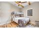 Bedroom with a bunk bed, ceiling fan, hardwood floors, and a decorative rug at 718 Emerson Gulch Rd, Boulder, CO 80302