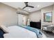A well-lit bedroom with a ceiling fan, closet, and a window offering views of the outdoors creates a peaceful atmosphere at 718 Emerson Gulch Rd, Boulder, CO 80302