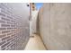 Exterior view of a modern home with a brick wall and concrete wall, showcasing a narrow pathway and minimal design at 718 Emerson Gulch Rd, Boulder, CO 80302