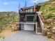 Modern exterior featuring a two-story design, a ground-level garage, and a second-story balcony with metal railings at 718 Emerson Gulch Rd, Boulder, CO 80302