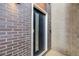Modern front door with sidelight, brick exterior, and concrete accent wall, creating a sleek and welcoming entry at 718 Emerson Gulch Rd, Boulder, CO 80302