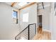 A hallway with hardwood floors, a skylight, and a stairway with metal railings for natural lighting at 718 Emerson Gulch Rd, Boulder, CO 80302