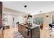 Open-concept kitchen featuring a large island with stone countertop, hardwood floors, and seamless flow to the living area at 718 Emerson Gulch Rd, Boulder, CO 80302