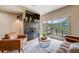 Cozy living room features a fireplace, comfortable seating, and a sliding glass door leading to a deck with mountain views at 718 Emerson Gulch Rd, Boulder, CO 80302