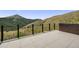 Large outdoor patio featuring a mountain view, a metal railing, and light stone pavers at 718 Emerson Gulch Rd, Boulder, CO 80302