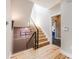 Bright hallway with a staircase featuring wood steps, modern railing, and stylish decor with a skylight above at 718 Emerson Gulch Rd, Boulder, CO 80302