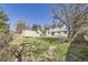 Large backyard with green grass and mature trees with a storage shed in the background at 4160 E 115Th Pl, Thornton, CO 80233