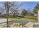 Spacious backyard with a patio, gravel bed, lawn, and trees at 4160 E 115Th Pl, Thornton, CO 80233