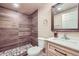 Bathroom featuring a stand-up shower with wood-look tile surround and pebble-style floor at 4160 E 115Th Pl, Thornton, CO 80233