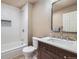Stylish bathroom features a shower over tub with white textured tile surround and a modern vanity at 4160 E 115Th Pl, Thornton, CO 80233