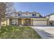 Charming two-story home with a well-manicured lawn, brick accents, and an attached two-car garage at 4160 E 115Th Pl, Thornton, CO 80233