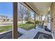 Relaxing covered porch with rocking chair, views of front yard and neighborhood at 4160 E 115Th Pl, Thornton, CO 80233
