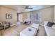 Open living room with large windows, neutral tones, and sleek modern furniture at 4160 E 115Th Pl, Thornton, CO 80233