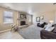 Comfortable living area with brick fireplace, large windows, and cozy seating arrangement at 4160 E 115Th Pl, Thornton, CO 80233