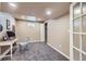 View of the basement office features neutral carpet, a closet, and a blue chair at 4160 E 115Th Pl, Thornton, CO 80233