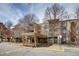 Condo building featuring multiple balconies, covered entrance, and bare trees at 1300 S Parker Rd # 288, Denver, CO 80231