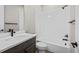 Clean bathroom with a white tiled shower/bath and a dark vanity at 16605 Peak St, Broomfield, CO 80023