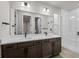 Modern bathroom with double vanity, quartz countertop, and glass enclosed shower at 16605 Peak St, Broomfield, CO 80023