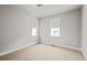 Bright bedroom featuring two windows and light neutral carpet at 16605 Peak St, Broomfield, CO 80023