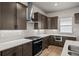 Modern kitchen features stainless steel appliances, stylish backsplash, and quartz countertops at 16605 Peak St, Broomfield, CO 80023