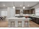 This kitchen features a large island with stool seating, stainless steel appliances, and modern pendant lighting at 16605 Peak St, Broomfield, CO 80023