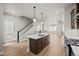 Spacious open-concept kitchen with island and stainless steel appliances leading into living room at 16605 Peak St, Broomfield, CO 80023