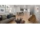 Open-concept living area with kitchen, dining, and living room with hardwood floors and stylish decor at 16605 Peak St, Broomfield, CO 80023