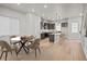 Open-concept living space with dining table and modern kitchen island at 16605 Peak St, Broomfield, CO 80023