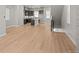 Open-concept living area flowing into the kitchen, featuring beautiful hardwood floors and ample space at 16605 Peak St, Broomfield, CO 80023