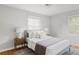 Bright bedroom with a large bed, neutral colors, and hardwood floors at 2970 Leyden St, Denver, CO 80207