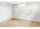 Simple bedroom with hardwood floors, a neutral wall paint, and a single window at 2970 Leyden St, Denver, CO 80207