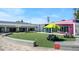 Open courtyard area featuring benches, picnic tables, and synthetic turf at 2970 Leyden St, Denver, CO 80207