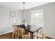 Bright dining room features contemporary light fixture and hardwood flooring at 2970 Leyden St, Denver, CO 80207