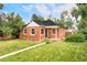 Charming red brick home with a well-manicured lawn and mature trees at 2970 Leyden St, Denver, CO 80207