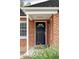 Inviting front door with classic brick surround and covered entry at 2970 Leyden St, Denver, CO 80207