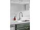 Close-up of the kitchen sink featuring a stainless steel faucet and white countertops at 2970 Leyden St, Denver, CO 80207