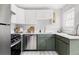 Modern kitchen features white cabinets, stainless steel appliances, and quartz countertops at 2970 Leyden St, Denver, CO 80207