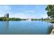 Scenic lake view with a distant fountain and city skyline, perfect for peaceful relaxation and enjoying nature at 2970 Leyden St, Denver, CO 80207